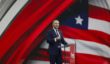 Karol Nawrocki standing on stage speaking passionately.