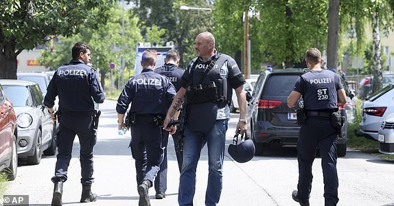 Police officers attend the scene of a shooting at a school in Graz, Austria, Tuesday, June 10, 2025. (Kleine Zeitung via AP)