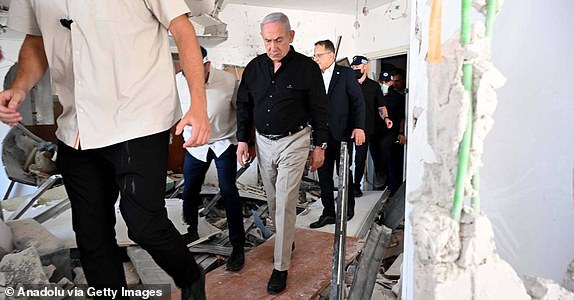 BAT YAM, ISRAEL  JUNE 15: (----EDITORIAL USE ONLY  MANDATORY CREDIT - 'AVI OHAYON / GPO / HANDOUT' - NO MARKETING NO ADVERTISING CAMPAIGNS - DISTRIBUTED AS A SERVICE TO CLIENTS----) Israeli Prime Minister Benjamin Netanyahu inspects demolished apartment buildings following Iran's launch of a ballistic missile attack against Israel in Bat Yam on June 15, 2025. (Photo by Avi Ohayon (GPO) / Handout/Anadolu via Getty Images)