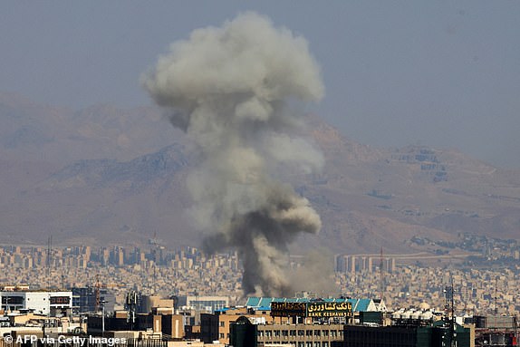 TOPSHOT - Smoke billows following an explosion in central Tehran on June 15, 2025. Iranian media said an Israeli strike hit the Tehran police headquarters in the city centre on June 15, as the two foes exchanged fire for a third day. (Photo by Atta KENARE / AFP) (Photo by ATTA KENARE/AFP via Getty Images)