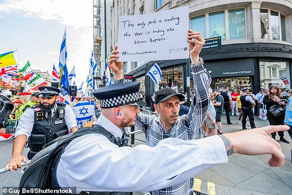 Mandatory Credit: Photo by Guy Bell/Shutterstock (15367885n) The large march passes (peacefully but passionately) a tiny (less than 50 people) at the Aldwych with the police acting as a small buffer zone - The latest National March for Palestine in London, stating in Russell Square and ending Whitehall. The protest takes place as Israel continues its assault on Gaza under cover of its new assault on Iran. Another National Demo for Palestine, London., Westminster, UK - 21 Jun 2025