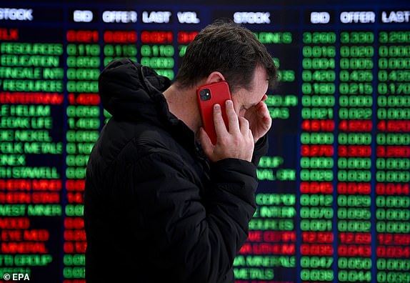 epaselect epa11526596 A person talks on the phone in front of indicator boards at the Australian Securities Exchange (ASX) in Sydney, Australia, 05 August 2024. The ASX has plummeted over fears of US recession, trading at its lowest single day since 2022.  EPA/BIANCA DE MARCHI AUSTRALIA AND NEW ZEALAND OUT
