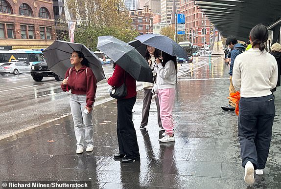 Mandatory Credit: Photo by Richard Milnes/Shutterstock (15314363c) People at the bus stops outside Central Station during rainy weather. Wet weather continues in Sydney, Australia, George Street, NSW - 22 May 2025 14771453  14858951