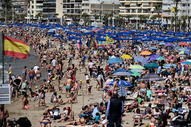 Holidaymakers crowd Levante Beach in Benidorm 