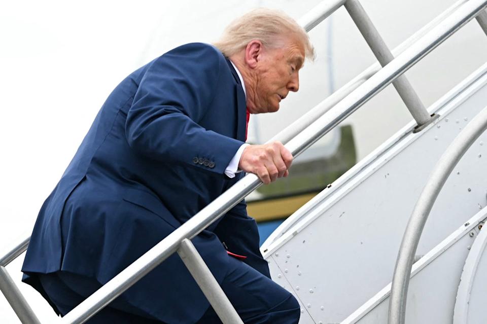 Trump stumbled as he made his way up the stairs of Air Force One on Sunday (AFP/Getty)