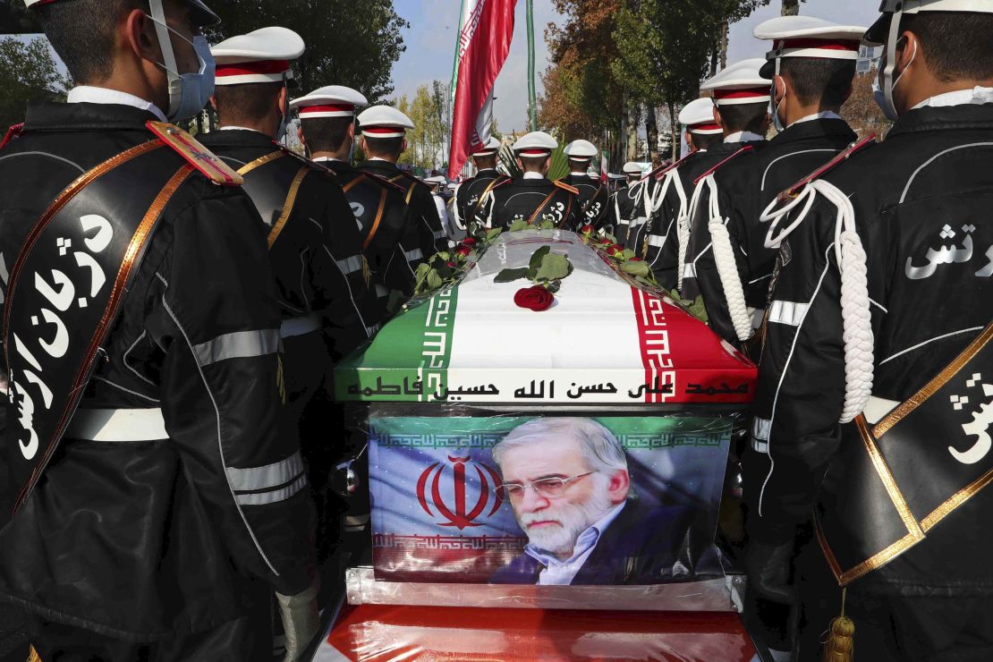 Military personnel stand near the flag-draped coffin of Mohsen Fakhrizadeh during his funeral in Tehran, Iran, on Monday, November 30. Iran claims it has evidence that Israel was behind <a href=