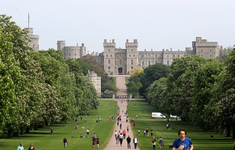 Windsor Castle and The Long Walk with people walking and enjoying the grounds.