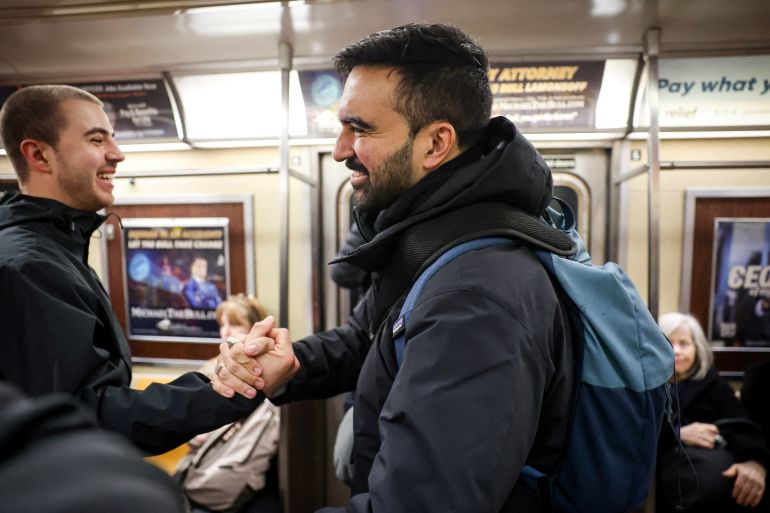 Candidate for New York City mayor Zohran Mamdani is greeted by a supporter on the subway following a campaign stop in New York City, U.S. April 1, 2025. REUTERS/Brendan McDermid
