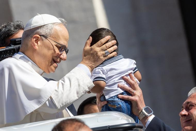 Pope Leo XIV blesses a baby at his May 28, 2025, general audience.
