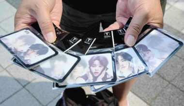 An Australian fan of K-pop band KTS holds travel cards with designs dedicated to the group  in Seoul, South Korea on June 13th 2023
