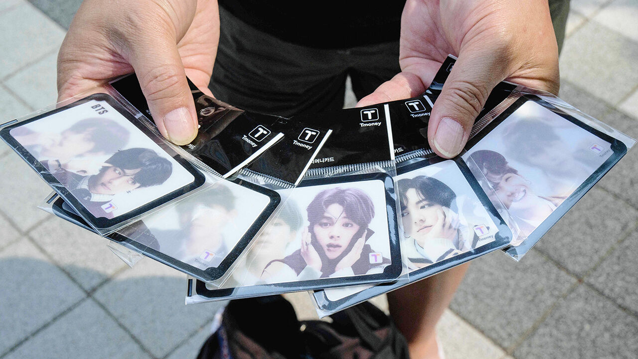 An Australian fan of K-pop band KTS holds travel cards with designs dedicated to the group  in Seoul, South Korea on June 13th 2023
