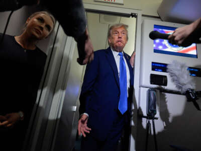President Donald Trump talks to reporters on board Air Force One with White House Press Secretary Karoline Leavitt after leaving early from the G7 Leaders' Summit on June 16, 2025, in Calgary, Alberta.