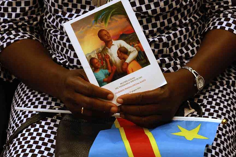 Faithful wait for the start of a beatification ceremony of Floribert Bwana Chui Bin Kositi, a Congolese man killed in 2007 for fighting corruption, in St. Paul Outside the Walls' Basilica, in Rome, Sunday, June 15, 2025. (AP Photo/Riccardo De Luca)