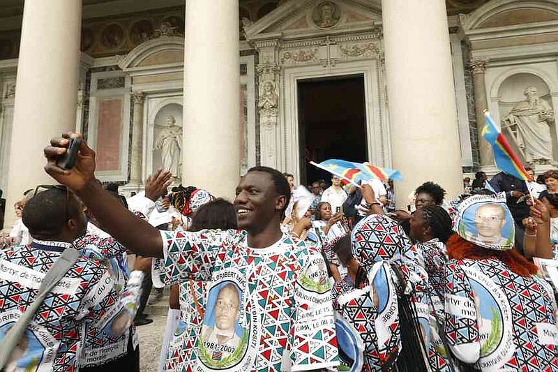 Faithful celebrate at the end of a ceremony for the beatification of Floribert Bwana Chui Bin Kositi, a Congolese man killed in 2007 for fighting corruption, in St. Paul Outside the Walls' Basilica, in Rome, Sunday, June 15, 2025. (AP Photo/Riccardo De Luca)