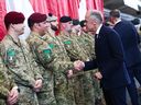 Prime Minister Mark Carney greets Canadian troops of the 4th Canadian Division as he attends a tour of the Fort York Armoury in Toronto on June 9, 2025. Carney announced Monday that Canada will meet the NATO spending target of two per cent of GDP by the end of this fiscal year.