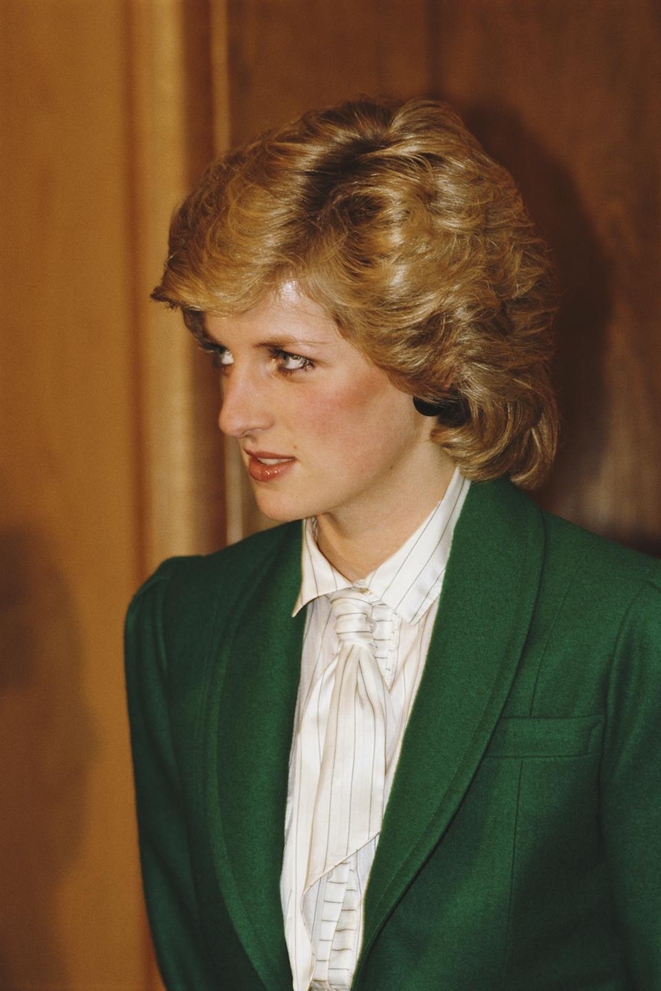 Princess Diana wearing a white tie and green jacket