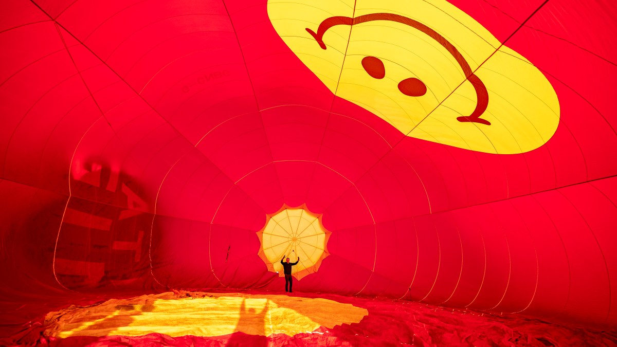 A pilot checks his balloon at dawn — and other news in pictures