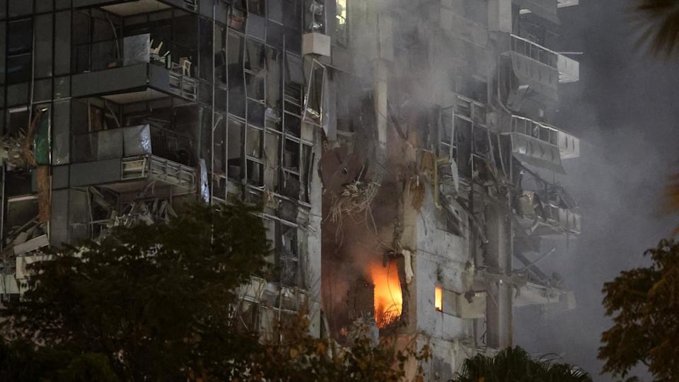 PHOTO: Fire and smoke rise from a building, reportedly hit by a missile fired from Iran, in central Tel Aviv, June 13, 2025.  (Jack Guez/AFP via Getty Images)