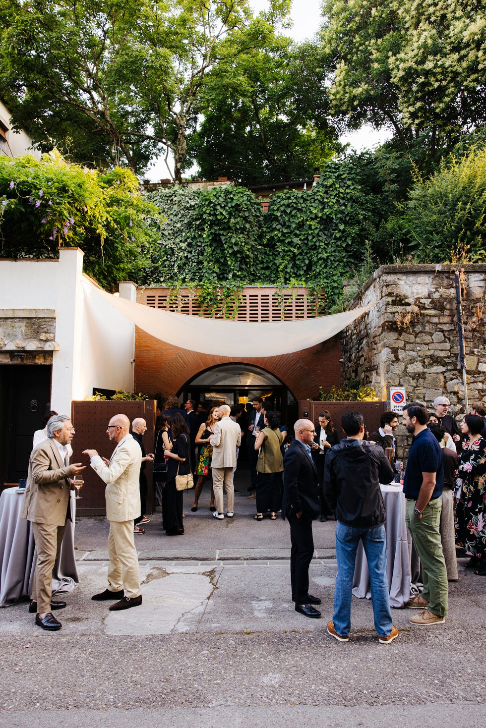 social gathering in an outdoor space with attendees and a natural setting