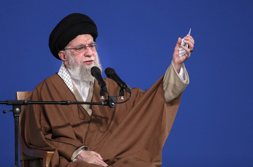 In this photo released by the official website of the office of the Iranian supreme leader, Supreme Leader Ayatollah Ali Khamenei speaks to a group of people and officials in Tehran, Iran, Friday, Mar ...