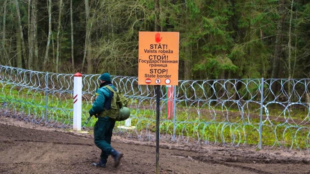 ARCHIVE - "Stop - state border" is written in three languages on the border with Belarus. Photo: Alexander Welscher/dpa