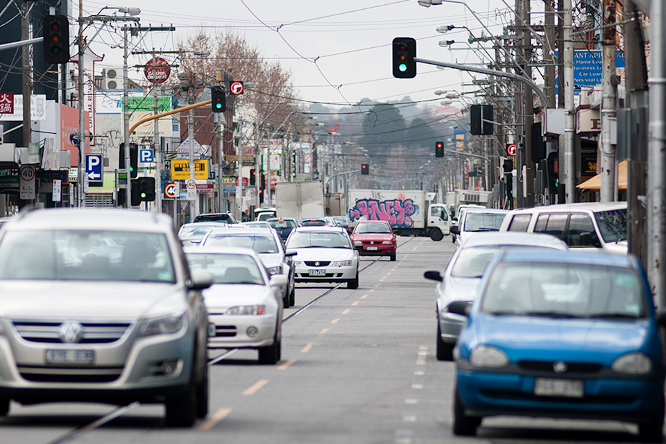 Cars flow through a Melbourne street.