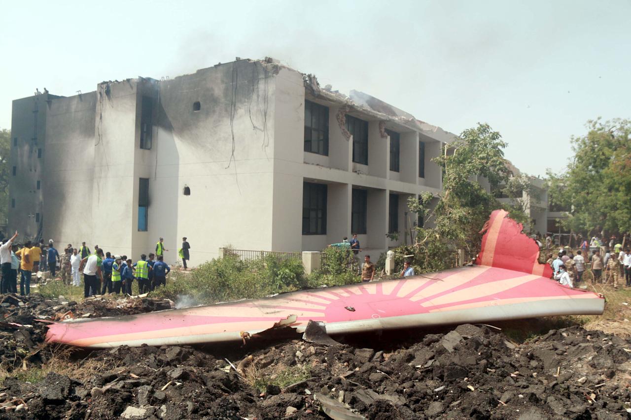 (250612) -- AHMADABAD, June 12, 2025 (Xinhua) -- People look at the debris of an Air India plane crashed in Ahmedabad of India's Gujarat state, June 12, 2025.  An Air India flight to London with 242 people on board, including two pilots and 10 cabin crew members, crashed Thursday shortly after takeoff from an airport in the western Indian state of Gujarat, officials said. Senior police officer confirms at least 110 dead in the crash, according to local media reports.    The flight took off from the Sardar Vallabhbhai Patel International Airport in Ahmedabad, about 17 km south of Gandhinagar, t