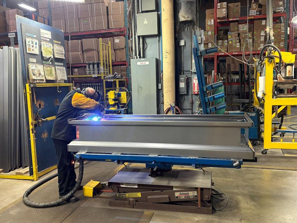 A welder at Magog Caskets is just one of fifty employees working at reduced hours due to the impact of tariffs.