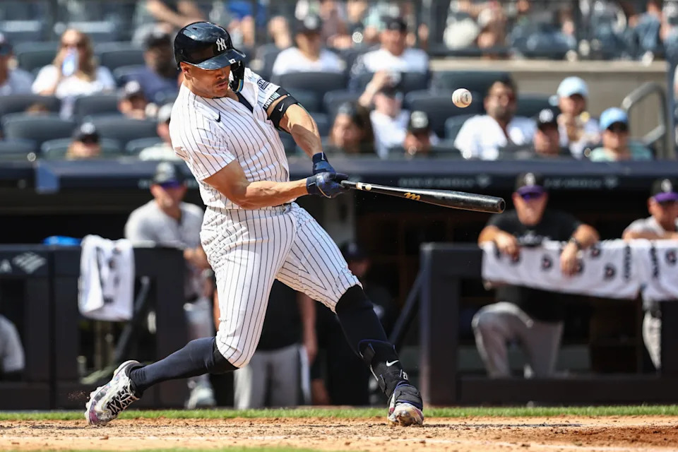 Aug 25, 2024; Bronx, New York, USA; New York Yankees designated hitter Giancarlo Stanton (27) hits a single in the fifth inning against the Colorado Rockies at Yankee Stadium. Mandatory Credit: Wendell Cruz-USA TODAY Sports © Wendell Cruz-USA TODAY Sports