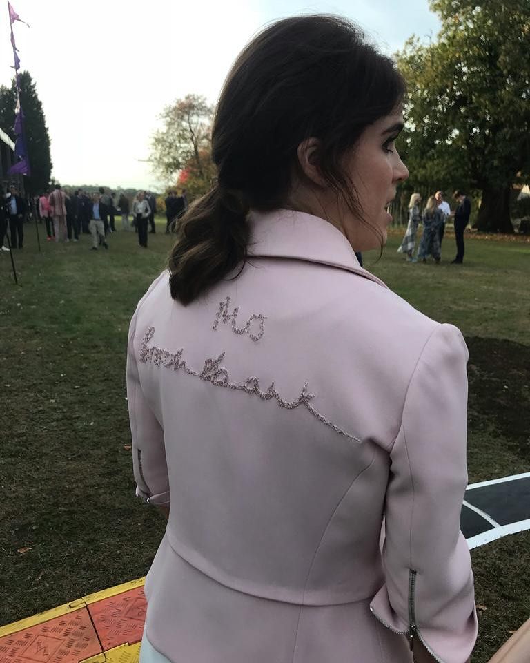 Princess Eugenie wearing a pastel pink jacket embroidered with 'Mrs Brooksbank'