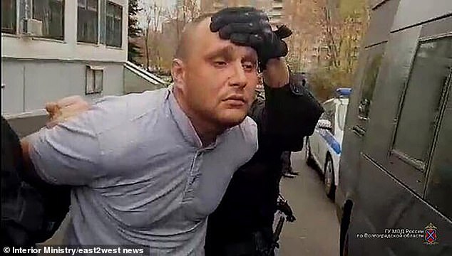 Maslennikov, a convicted rapist and murderer, is pictured being put into a police van