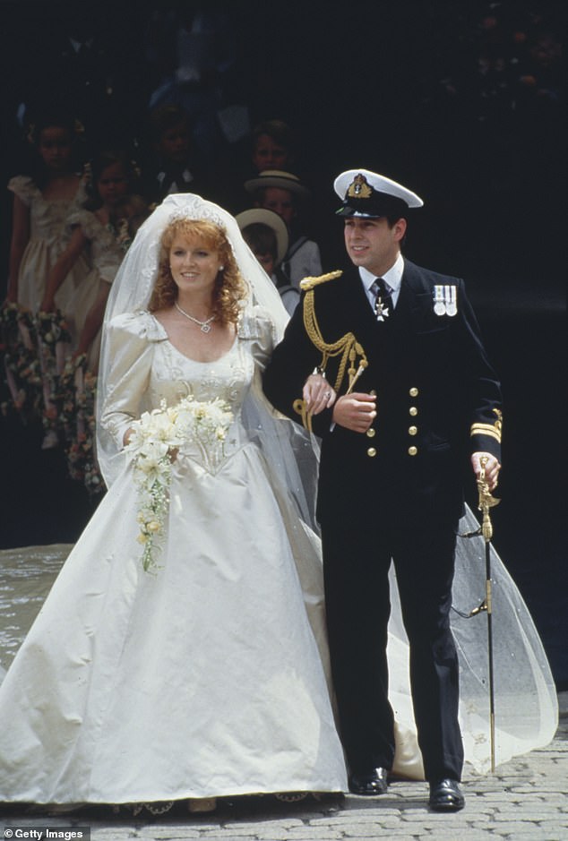 Sarah, Duchess of York, wearing an ivory-silk Lindka Cierach wedding dress, and Prince Andrew, Duke of York, wearing the ceremonial uniform of a Royal Navy lieutenant, arm-in-arm following their wedding ceremony at Westminster Abbey