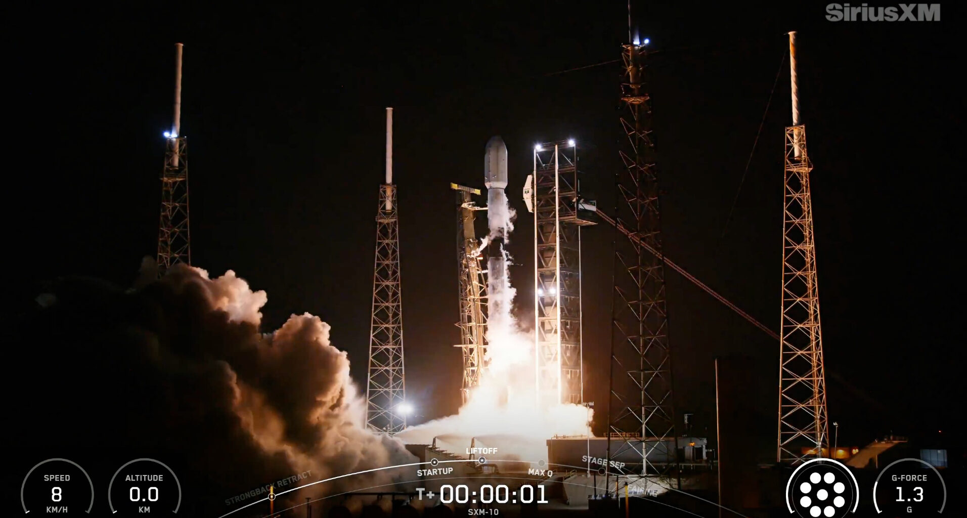 a black and white rocket launches into a dark night sky