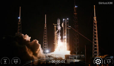 a black and white rocket launches into a dark night sky