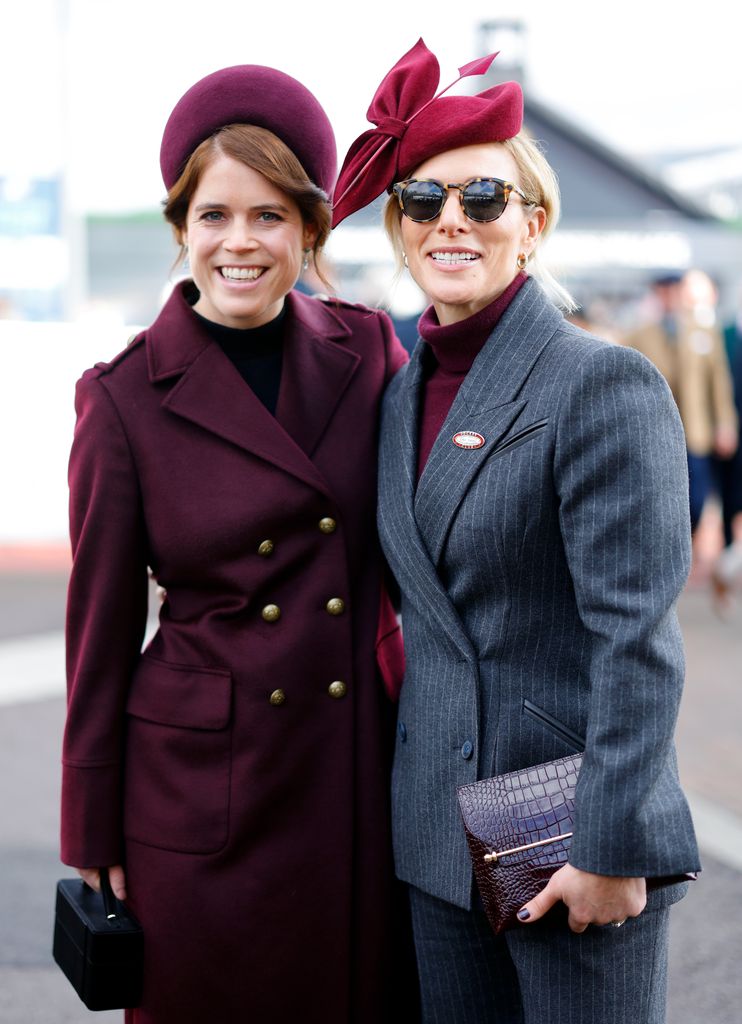 Eugenie and Zara wearing burgundy outfits at Cheltenham