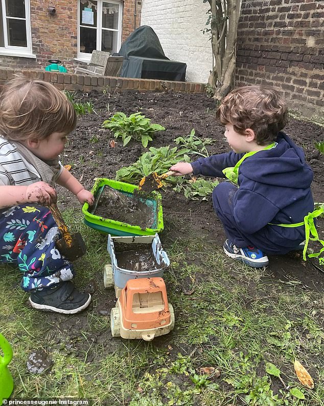 August and Ernest play together in the mud in another of the photographs from Eugenie