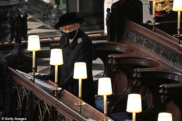 Queen Elizabeth II watches as pallbearers carry the coffin of Prince Philip, Duke Of Edinburgh into St George's Chapel