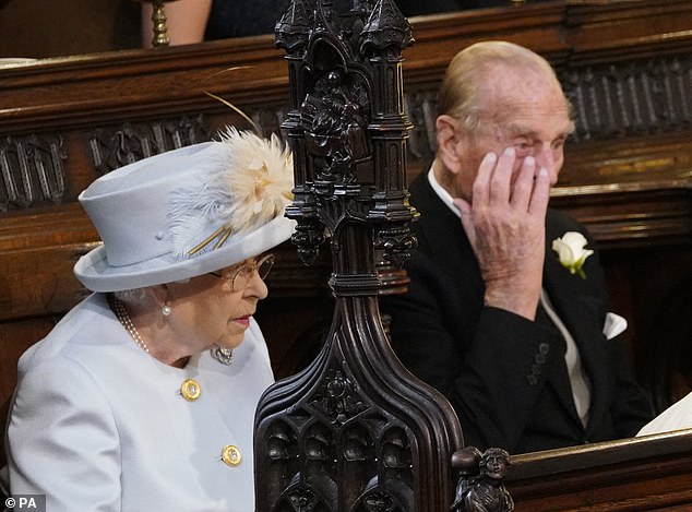 The late Queen and Prince Philip are pictured at Eugenie's wedding on the second row of the chapel pews