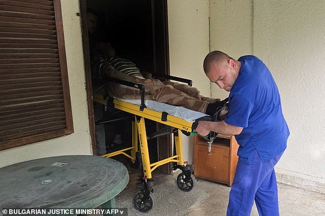 The facilities, in the village of Yagoda, near city Stara Zagora, were run as so-called health centres for the elderly, offering 'rooms for rent' for around 400 Euros per month. Pictured: An elderly person transported out of the facilities by a healthcare worker