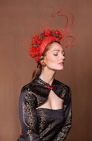 This burnt orange crescent boasts handmade roses, quills and veiling