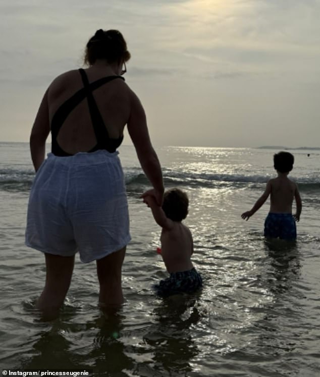 Princess Eugenie shared a photograph of herself at the beach with her sons August and Ernest for World Ocean Day on Sunday (pictured from L to R: Eugenie, Ernest, August)