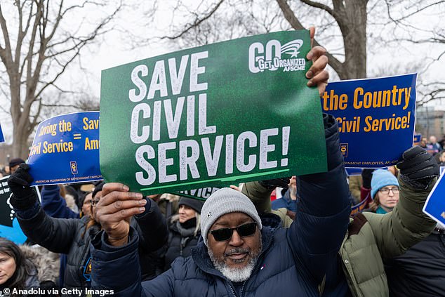 Members of the American Federation of Government Employees (AFGE) union protest against firings during a rally to defend federal workers in Washington, DC on February 11, 2025