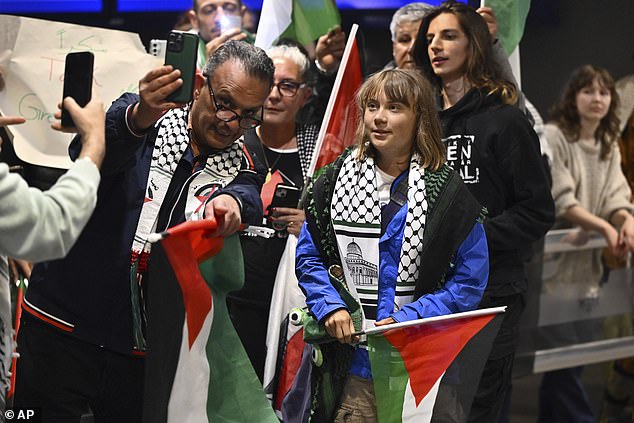 Of the 12 people on board the sailing boat Madleen, two French nationals agreed to be deported on June 10, while four others declined pending a court decision. Pictured: Thunberg was greeted by around 30 cheering supporters waving Palestinian flags amid a large media presence at the airport