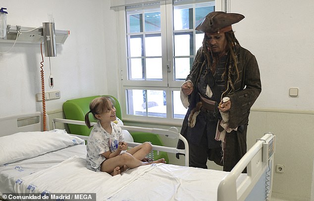 One little girl can be seen above smiling as she spoke to Depp from her hospital bed