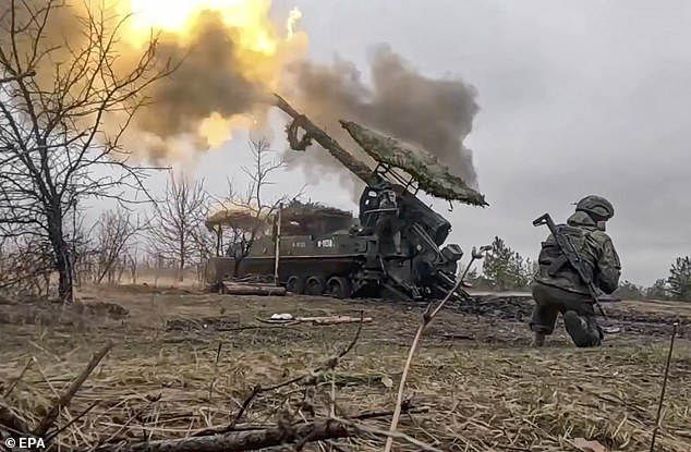 Russian troops fire toward Ukrainian positions at an undisclosed location in Ukraine