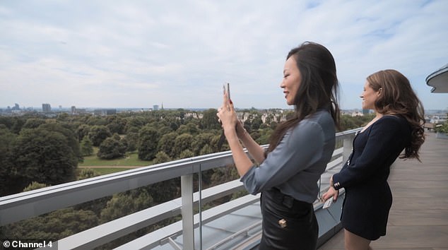 Dara Huang (left) photographs the view alongside real estate agent Constance Cunningham