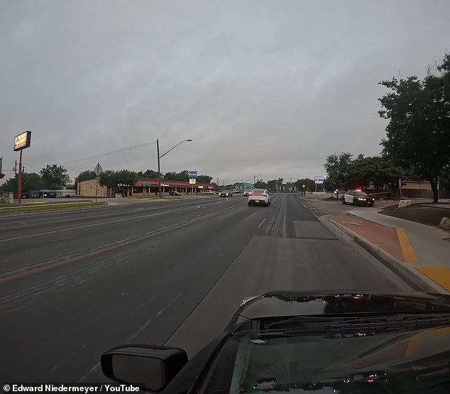 Another Robotaxi (pictured) came to a full stop on an active roadway after detecting a nearby police cruiser in a parking lot