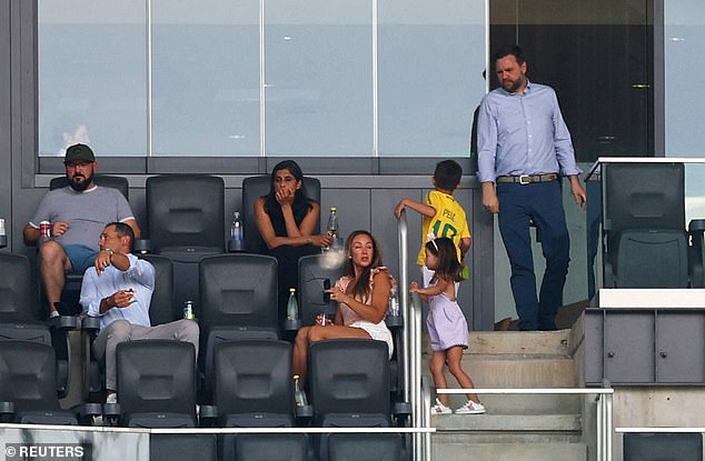 Vance walks to his seat in the VIP section to watch the Club World Cup game on Wednesday