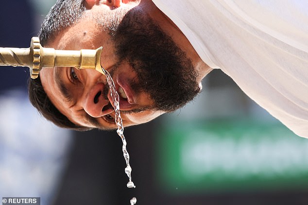 BOSNIA AND HERZEGOVINA: A tourist drinks water at a fountain during a heatwave in Sarajevo, June 25