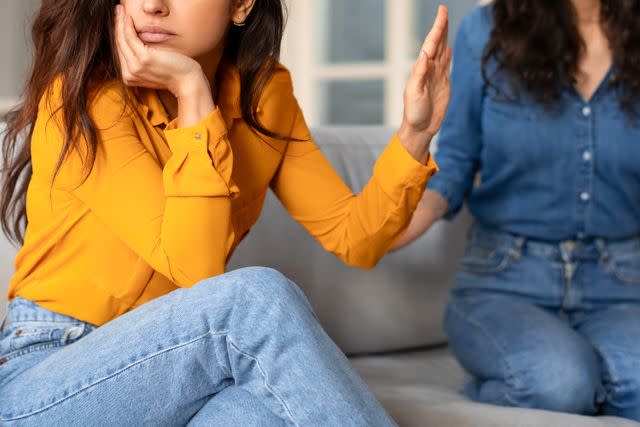 Stock photo of woman dismissing her family member